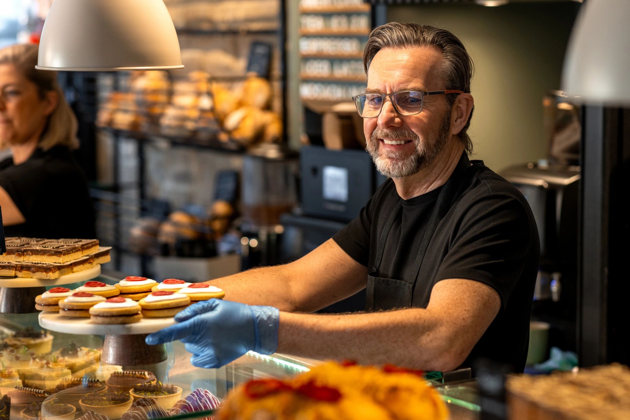 Staff member working carefully in a food preparation setting